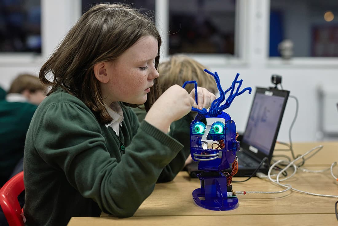 Child building an Ohbot robot