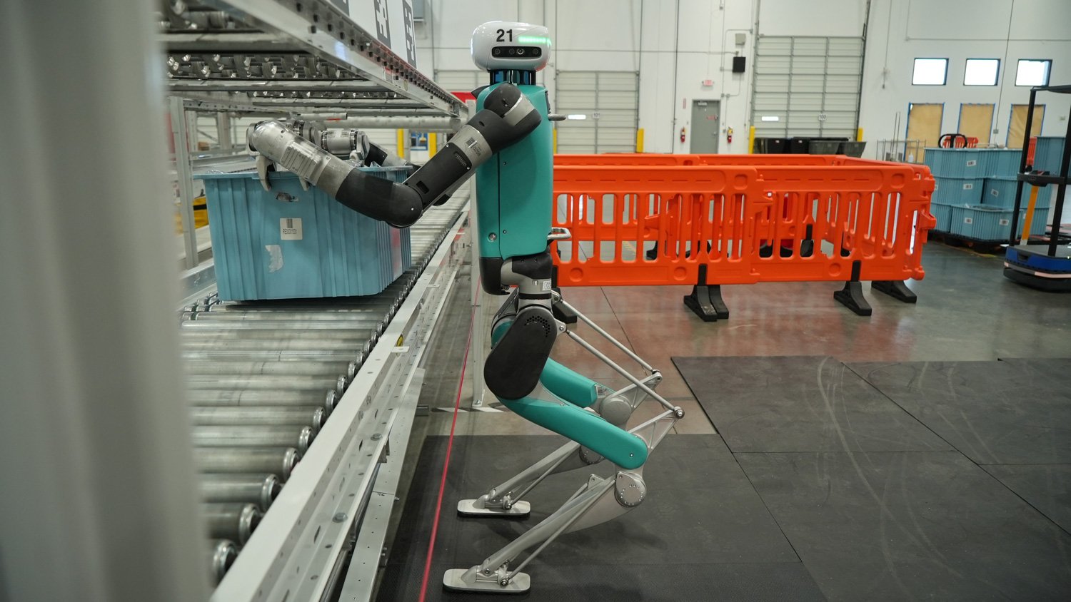 Digit carrying a warehouse tote during the GXO deployment.