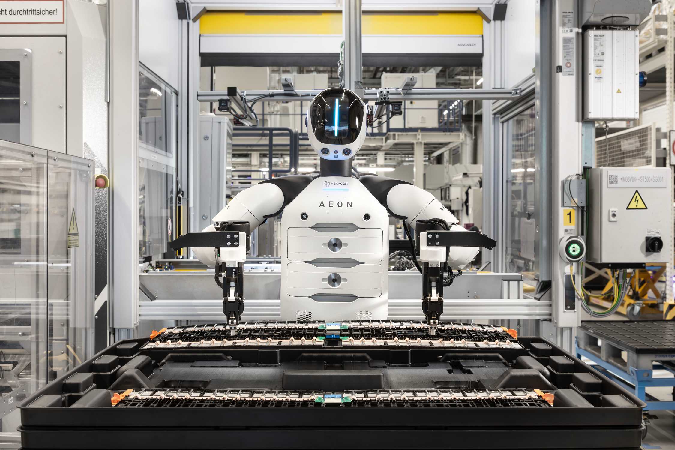 A humanoid robot being tested inside a BMW production facility.